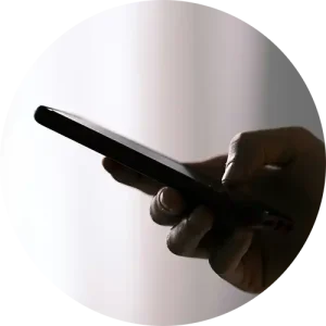A person holding a mobile phone in their hand.